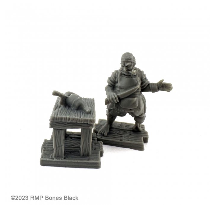 20730 Cook & Table sculpted by C Van Patten from the Reaper Miniatures Bones Black range. A limited edition RPG miniature representing a ships cook holding a kitchen knife and a table with a joint both on wood effect bases for your tabletop games.