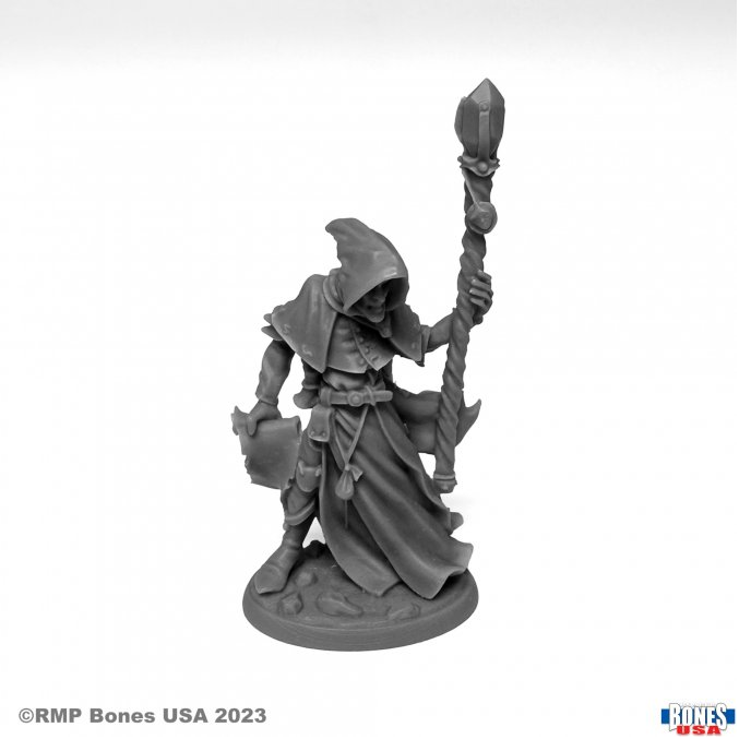 30101 Reaper Miniatures Satheras Elf Warlock sculpted by Bobby Jackson from the Reaper Bones Legends USA range, a characterful tabletop gaming miniature of a hooded Elf holding a scroll in one hand and a staff in the other.