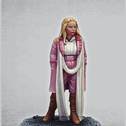 Temporal Traveller 5J by Crooked Dice a white metal miniature for your tabletop games representing a woman with shoulder length hair, wearing knee high boots, extra long scarf and has her hands in the pockets of her coat.