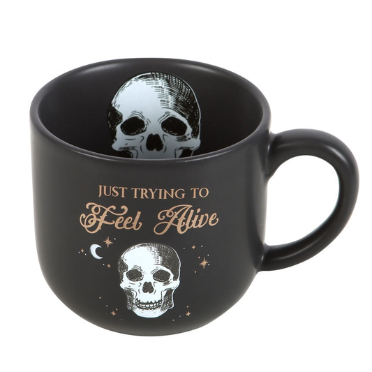 A black mug with a white skull p...