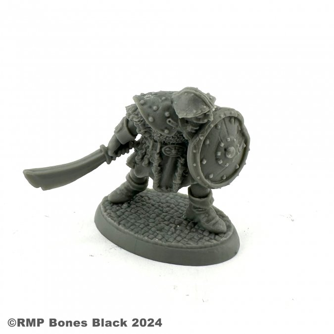 20319 Orc Warrior with sword down by Reaper Miniatures from their Bones Black range sculpted by Bobby Jackson for your tabletop gaming needs. A great gaming figure of an Orc holding a shield in front and a sword by the side
