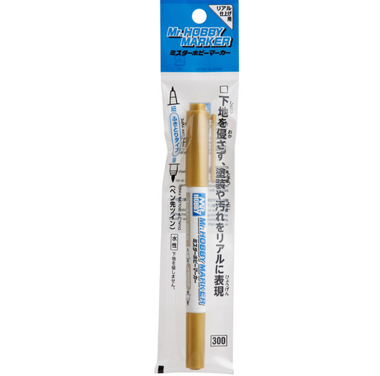 Gold marker with a white cap on ...