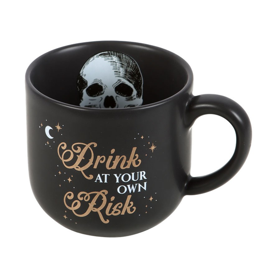 A black mug with a white skull p...