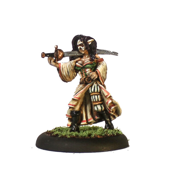 Cacciatore 5 by Oakbound Stuido. A lead pewter miniature of a female with her hair down, wearing a mask and cat ears, a long dress and holding a sword precariously over her shoulder, a great miniature for your tabletop and RPGs