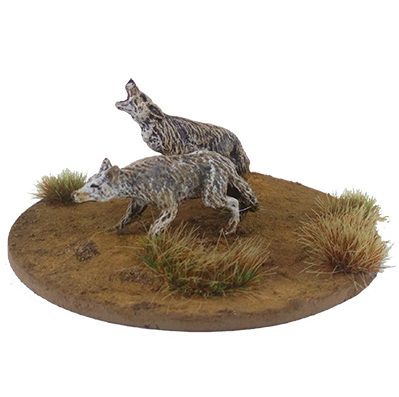 Two wolf figurines on a round ba...