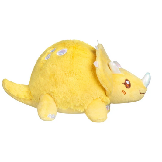 A yellow plush toy triceratops d...