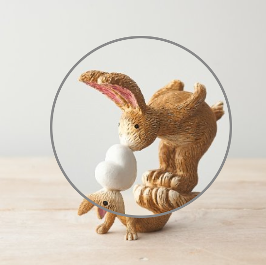 Wonderful bunny ornament of a rabbit and baby bunny adorably posed with the baby bunny standing on the rabbits feet and nose kissing a heart. A sweet figurine that would make a beautiful gift or edition to your own home.