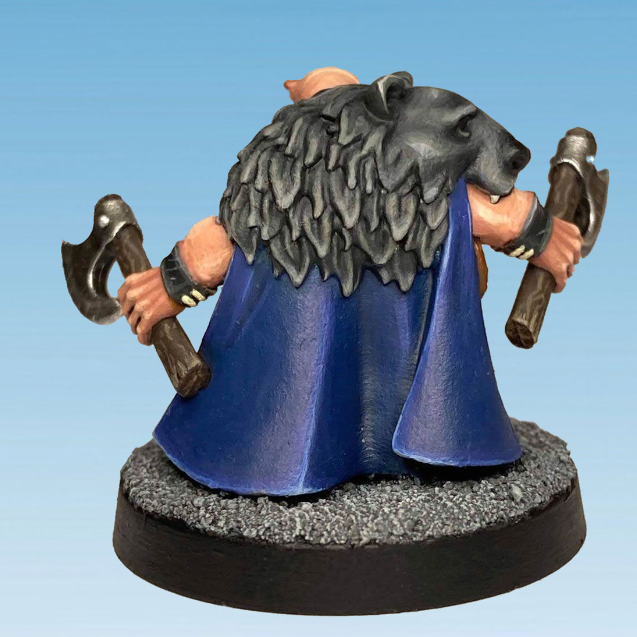 Dwarf Berserker 2 by Crooked Dice, one 28mm scale white metal miniature for your RPG or tabletop game representing a dwarf with a long beard, holding an axe in each hand and wearing a bear skin with the head on his shoulder. 