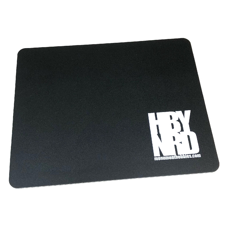 Hobby Nerd Cutting Mat, 10"x8" double-sided self-healing mat with HBY NRD logo, solid black on the back. Ideal for hobbyists' projects.