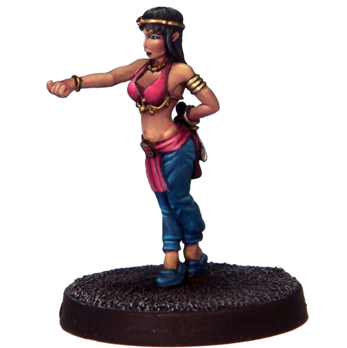 Jamilah Harem Assassin by Crooked Dice, a white metal miniature for your tabletop games. This female miniature is wearing a belly dancer style outfit and hides a blade behind her back