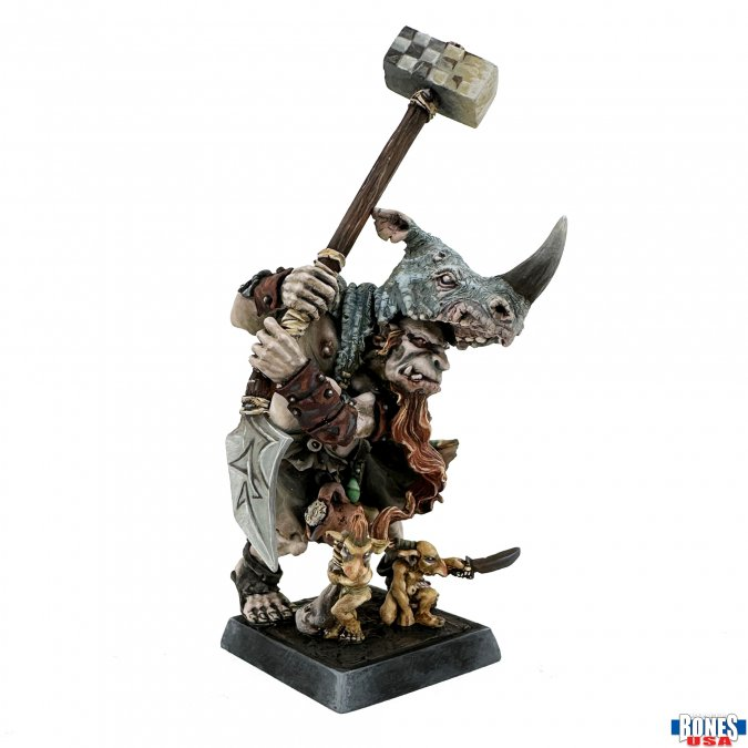 Unpainted Ogre Mercenary miniature by Werner Klocke, featuring a hammer, shield, helmet shaped like a rhino head, textured base, and smaller creatures by his feet.
