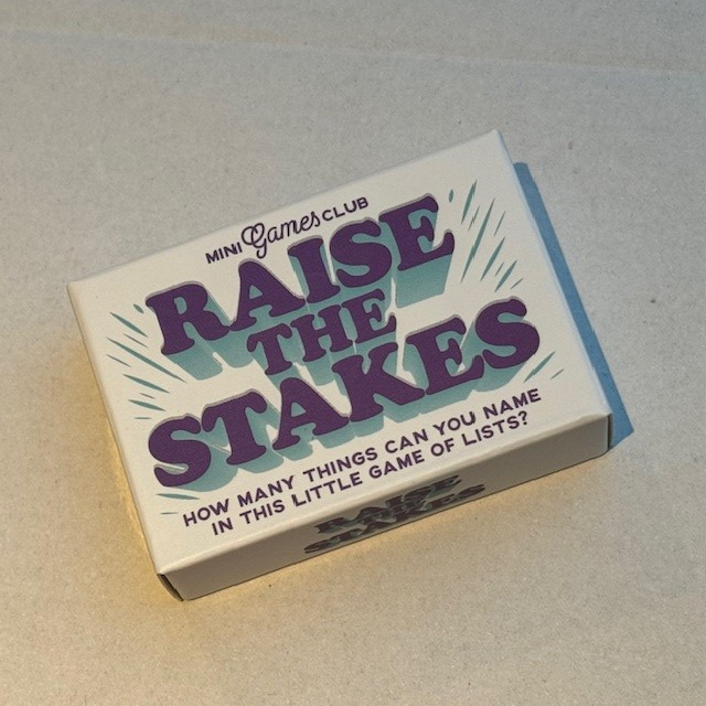 Raise The Stakes mini matchbox game. a small white box with purple writing