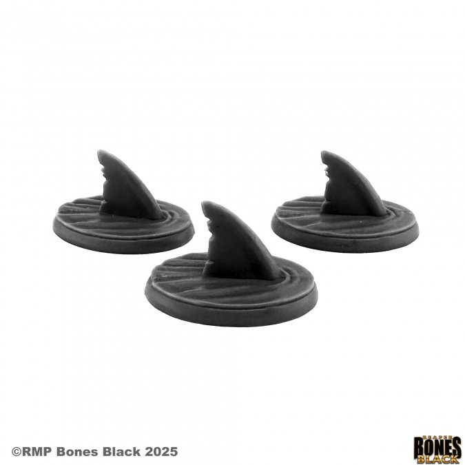 Three black shark fin-shaped gaming tokens on a white background with 'RMP Bones Black' branding. Reaper Miniatures Shark Fins (3) Bones Black 25mm heroic scale unpainted circular bases with shark fins