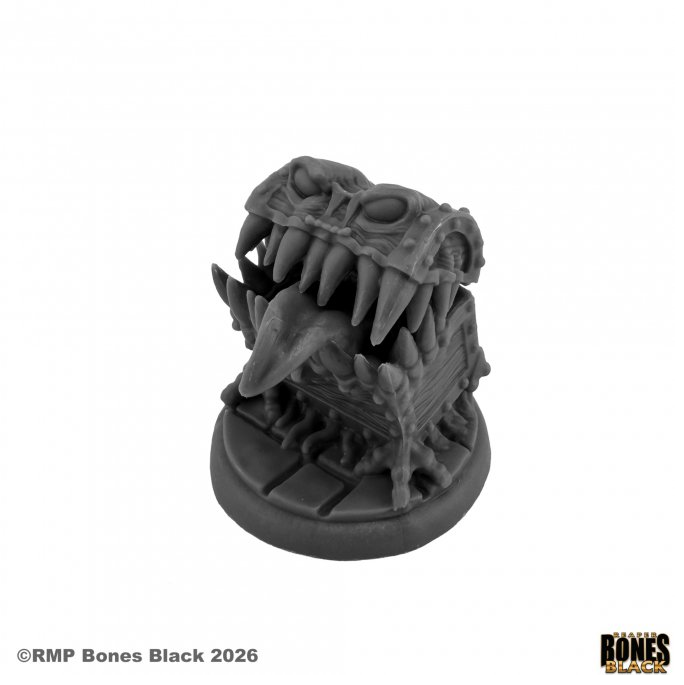 A dark Gray unpainted tabletop gaming miniature of a monstrous skull-like head with sharp teeth and a skeletal base, shown on a white background with RMP Bones Black branding. Reaper Miniatures Briggley the Mimic