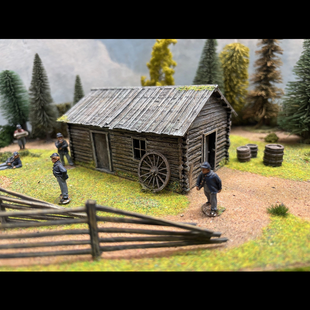 Timber Cabin. A 1/56th scale hard plastic model kit featuring a log-built structure for 28mm wargaming. Requires assembly and painting.