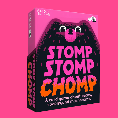 Card game box for 'Stomp Stomp Chomp' on a pink background