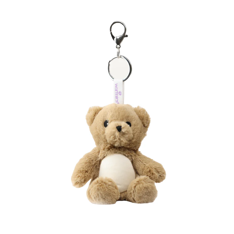 Plush teddy bear keychain with a tag on a white background. Warmies Brown Bear Bag Charm Plushie