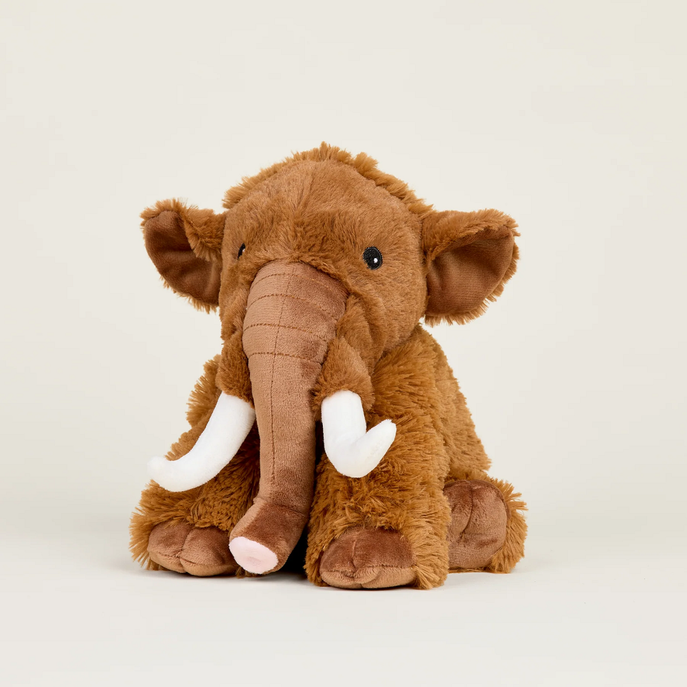 Warmies® Woolly Mammoth. Brown plush elephant toy on a light beige background