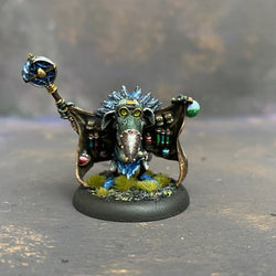 Beaky Bobby from the Moonstone Goblin city troupe box,  pre painted by Mrs MLG. This wonderfully sculpted miniature has everything potion and poison you could need, it just may not be all above board, he also has a few tricks up his sleeves so be careful when dealing with this particular goblin. This delicate miniature is painted with greens, blues and browns. 