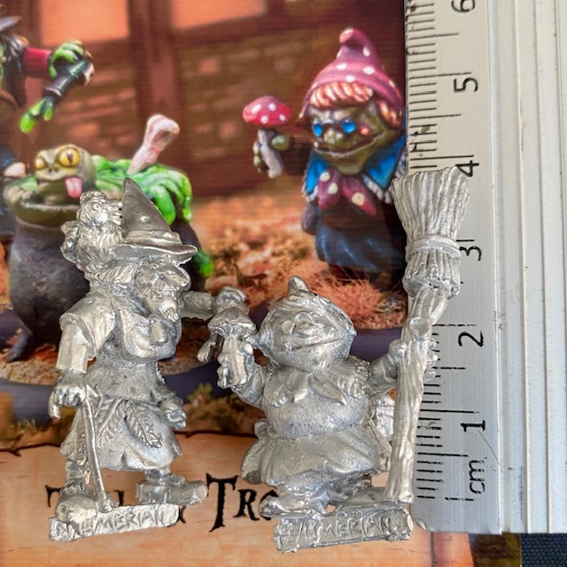 Toil And Trouble by Northumbrian Tin Solider is a set of 3 miniatures, two witches and a cauldron. One witch has a walking stick and pointed hat, one holds a broom and a mushroom and the cauldron contains the spell being cooked up and a frog attempting to escape.