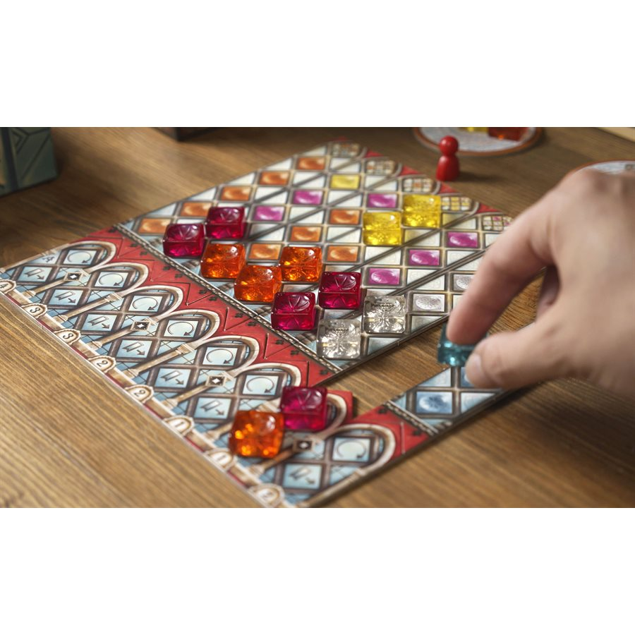 Azul Stained Glass Of Sintra. A hand placing a glass tile onto the game board