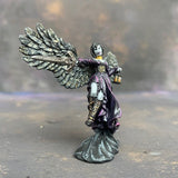 Angel of Shadows from the reaper miniatures bones range pre painted by Mrs MLG. This angelic miniature is painted with purples, blues, grey and golds, she holds a sword in one hand and a lantern in the other.
