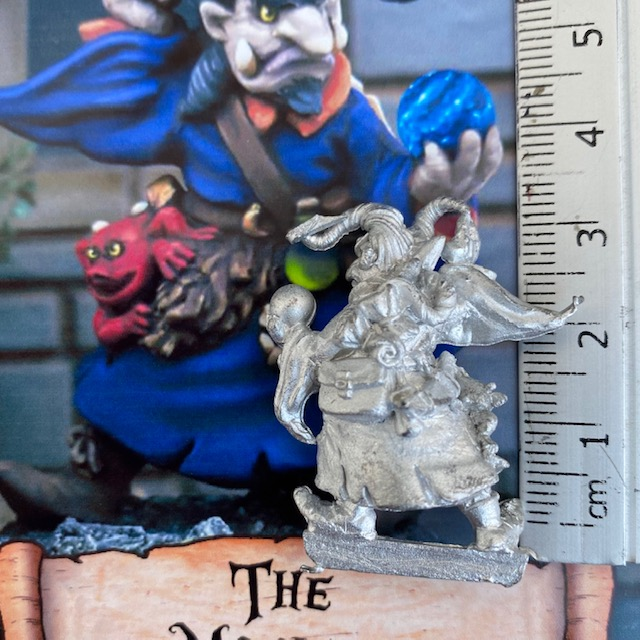 This wizard holds a crystal ball on one hand in a stance as if to cast a spell, with scrolls at his back and a creature on his hip The Magicka by Northumbrian Tin Solider