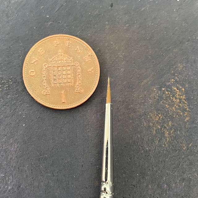 Series 98 Triangular Pure Sable - 2/0 - Rosemary & Co paint brush tip next to a 1p
