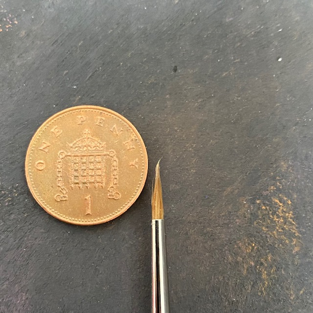 Series 98 Triangular Pure Sable - 1 - Rosemary & Co paint brush tip next to a 1p