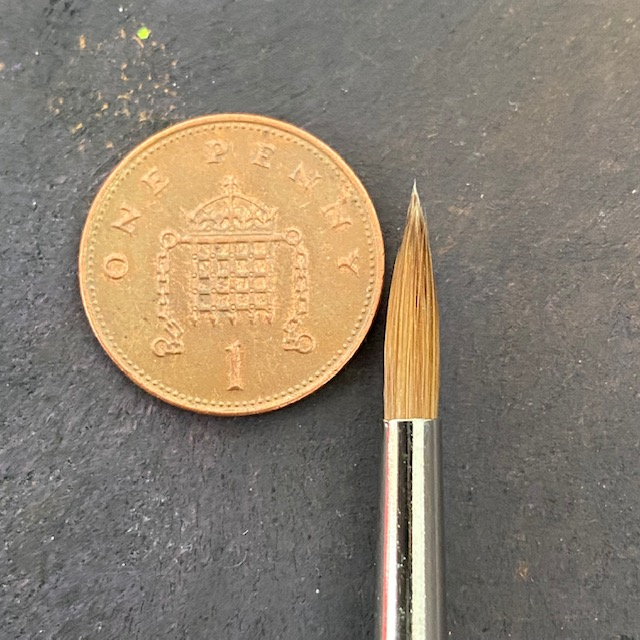 Series 98 Triangular Pure Sable - 6 - Rosemary & Co paint brush tip next to a 1p