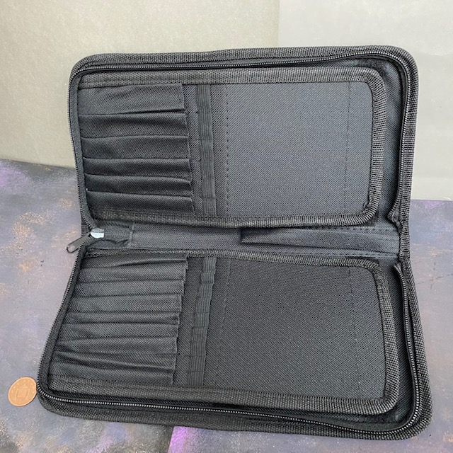 A Rosemary & Co brush case. This black case has a zip fastening and six dividers for large brushes and nine dividers for smaller brushes.