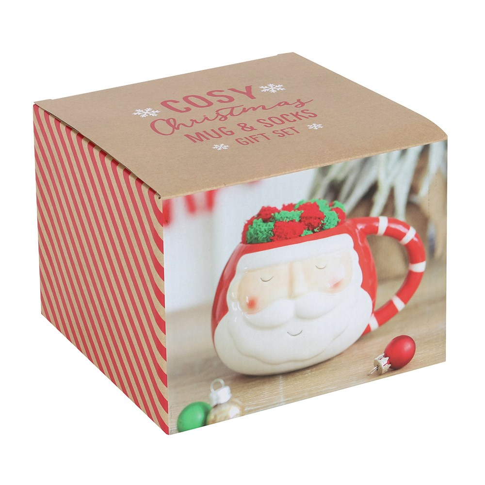The box for A rounded mug with Santa face design and red and white stripe handle with a pair of red and green stripped fluffy socks