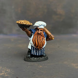 Tub the Dwarf Baker from the Reaper Miniatures Bones USA range pre painted by Mrs MLG.  This slightly grumpy looking baker has his wonderfully scrumptious pie in one hand and a rolling pin over his shoulder in the other, painted with blues and whites and sporting an elegant ginger beard. 