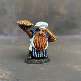 Tub the Dwarf Baker from the Reaper Miniatures Bones USA range pre painted by Mrs MLG.  This slightly grumpy looking baker has his wonderfully scrumptious pie in one hand and a rolling pin over his shoulder in the other, painted with blues and whites and sporting an elegant ginger beard. 