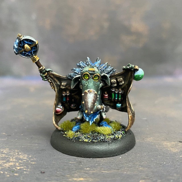 Beaky Bobby from the Moonstone Goblin city troupe box, pre painted by Mrs MLG. This wonderfully sculpted miniature has everything potion and poison you could need, it just may not be all above board, he also has a few tricks up his sleeves so be careful when dealing with this particular goblin. This delicate miniature is painted with greens, blues and browns.