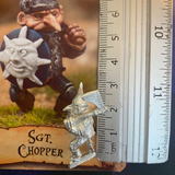 Sargent Chopper by Northumbrian Tin Solider is an old school style metal miniature for your gaming table holding an axe over his shoulder and a round shield in his other hand., shown here with a ruler