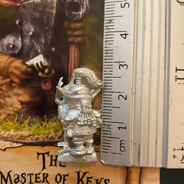 The Master of the Keys by Northumbrian Tin Solider holds a large key in one hand and a smaller key on the other hand. Shown with a ruler