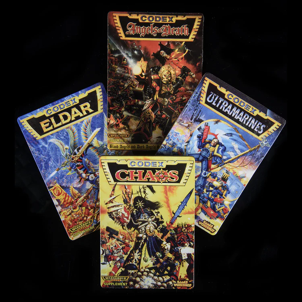 Warhammer 40k 2nd Edition Codex Coasters. Four rectangle shaped corkboard laminated coasters featuring Ultramarines, Angels of Death, Chaos Space Marines and Eldar Codex designs making a great gift for a Warhammer 40k fan.