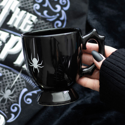 The mysterious Spider Teacup boasts a black, thorny handle, with a striking white spider accent for a touch of spooky style. A perfect addition to any elegant and sophisticated kitchen or home ware collection