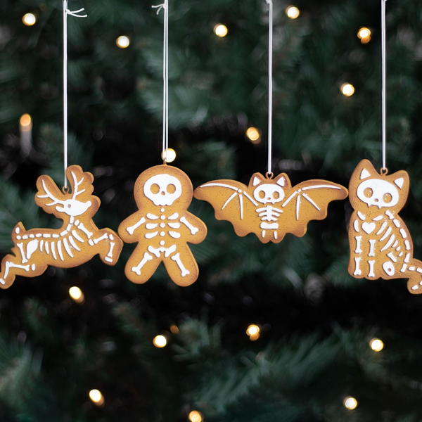 Set of four Creepy Skeleton Cookie Ornaments. A spooky take on the traditional gingerbread cookie ornaments featuring a gingerbread man, skeleton reindeer, bony bat and creepy cat