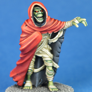 Abomination by Crooked Dice a white metal 28mm miniature for your tabletop games, a mummified creation with bandages hanging off and wearing a cloak that you could use in many RPGs or 80s nostalgia games. 