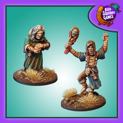 Bad Squiddo Games Shaman & Apprentice. A pack of two metal miniatures by Bad Squiddo Games representing a female shaman and her apprentice, the older shaman has a bandage across her eye while the more spry apprentice raises bandaged arms and adorns a chest plate of bones
