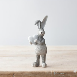 Grey Standing Rabbit With White Heart. A cute bunny figure with one ear folder down, holding a white heart making a wonderful edition to your rabbit ornament collection or as a gift. 