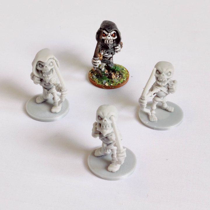 Skeletons set E by Iron Gate Scenery in chibi style.&nbsp; A set of four 28mm scale printed weapon wielding skeletons.