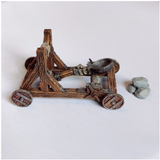 A Catapult by Iron Gate Scenery in 28mm scale produced in PLA representing a wooden catapult weapon. Contains one catapult, one single boulder and one pile of boulders your tabletop gaming, RPGs and hobby dioramas.