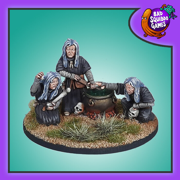 Bad Squiddo Games The Graeae Witch Coven. A pack of three metal miniatures representing witches creating spells, or just dinner, in a cauldron there main problem being that they only have one eye between them and have to pass it around with the bone holding witch currently using it to keep an eye on the boiling pot.