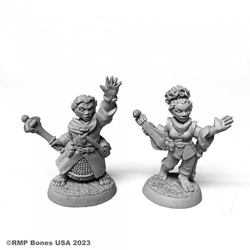07103 Halfling Cleric & Bard sculpted by Derek Schubert from the Reaper Miniatures Bones USA Dungeon Dwellers range. A set of two Halfling RPG miniatures one representing a cleric wearing a bag and holding one hand in the air, the other a female bard with hair tied up and instrument on hip making a great guard for your gaming table.    