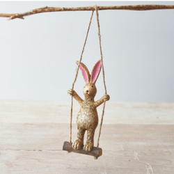 Standing Rabbit On A Swing. An adorable bunny figurine standing on a swing enabling you to hang this cute rabbit in your home, work or window. A quirky animal decoration for yourself or as a gift. 