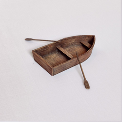 A small PLA boat by Iron Gate Scenery in 28mm scale with two oars provided unpainted for your tabletop games and hobby needs.