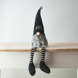This sitting gnome is a ghoulishly delightful addition to your home with its striped legs and black hat featuring the word 'Boo' embroidered in white.